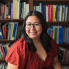 Karina Santellano infront of a bookshelf